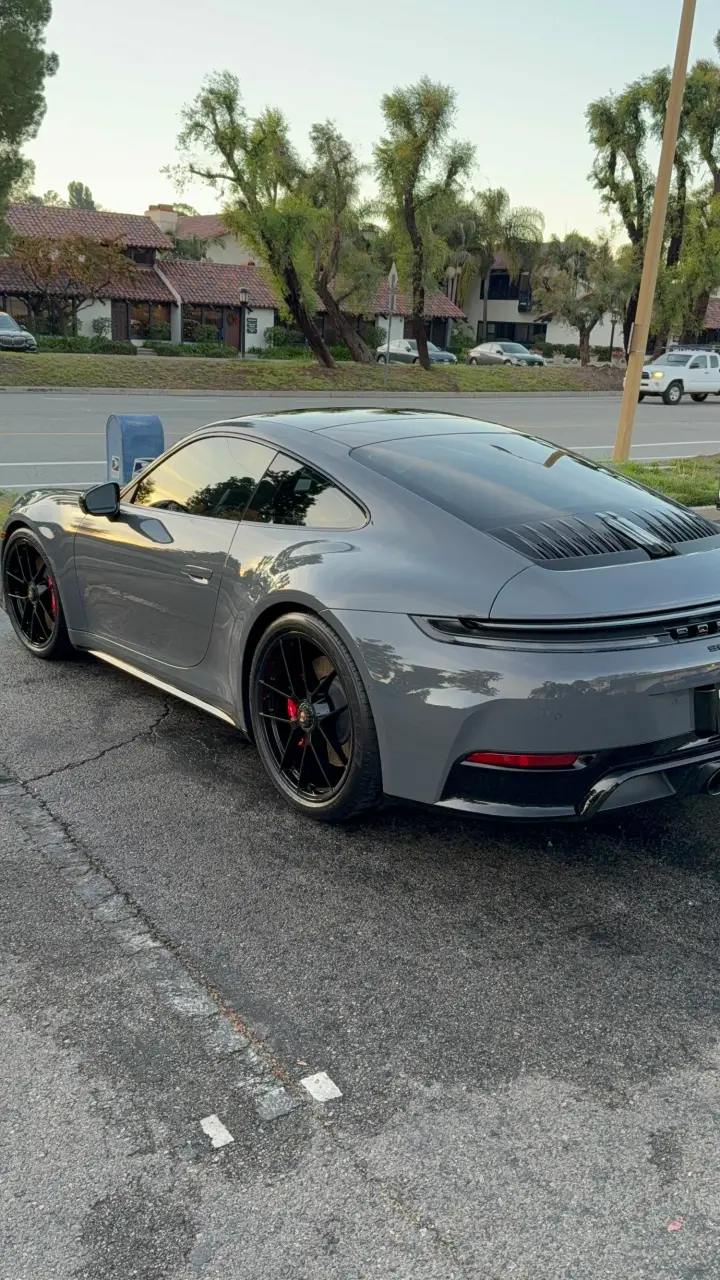 Grey Porsche 911 on a residential street after an exterior detail