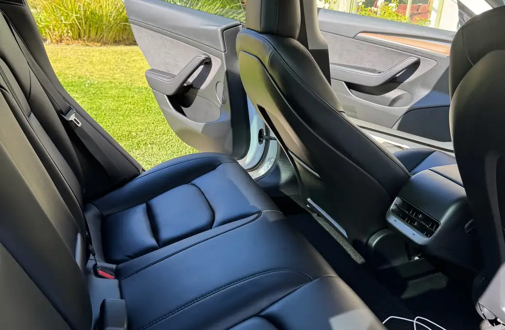 Freshly detailed black leather rear seats with the door open